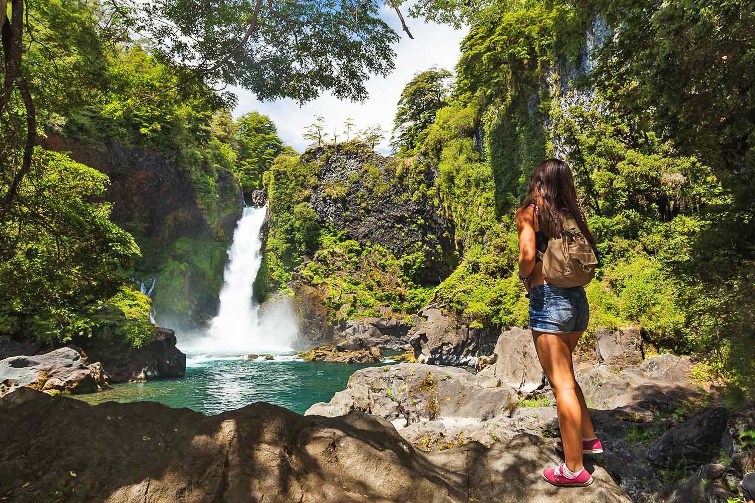 Viajera frente a cascada en el bosque de huilo huilo